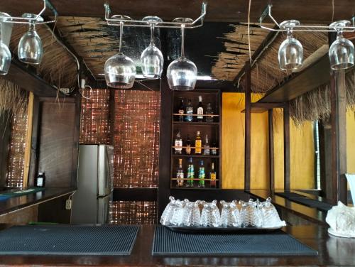 a bar with a bunch of bottles on a counter at Eddie`s Beach Resort Siargao in General Luna