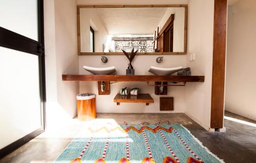 a bathroom with two sinks and a rug on the floor at Tulum Private Villa, Weddings, Retreats, Groups in Tulum