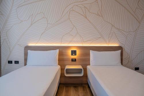 Ένα ή περισσότερα κρεβάτια σε δωμάτιο στο Days Inn by Wyndham Juan Dolio