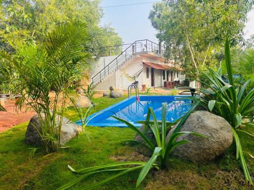 a swimming pool in the yard of a house at Cozy haven in Auroville