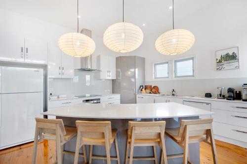 a kitchen with a large white table and chairs at 65 McLeod Rd Middleton Pet Friendly Wi-Fi - No Linen Included in Middleton