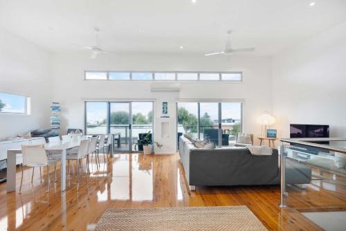a living room with a couch and a table and chairs at 65 McLeod Rd Middleton Pet Friendly Wi-Fi - No Linen Included in Middleton