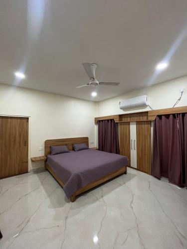 a bedroom with a bed and a ceiling at ClubGreens in Jorhat