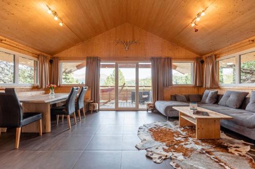 a living room with a couch and a table at Alpenpark Turrach by ALPS RESORTS in Turracher Hohe