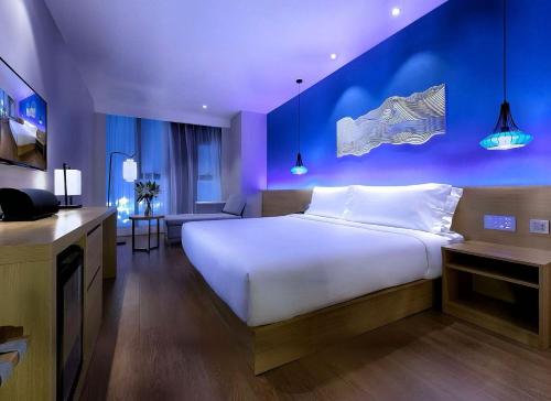 Postel nebo postele na pokoji v ubytování Orange Hotel Hangzhou Binjiang University Town