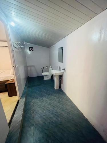 a white bathroom with a sink and a mirror at Casa Beach hut Resort in Palolem