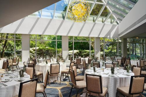 a banquet hall with tables and chairs and a chandelier at Hilton McLean Tysons Corner in Tysons Corner
