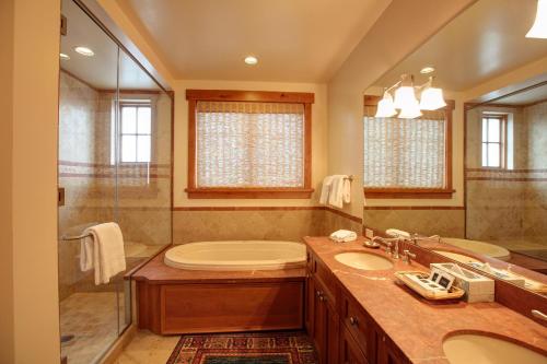 a bathroom with a tub and a sink and a shower at The Lodge at Spruce Peak, a Destination by Hyatt Residence in Stowe