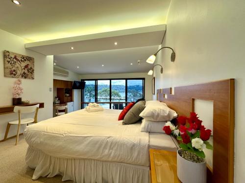 a bedroom with a large bed with flowers on it at BlueWater Penthouse GuestSuite 2 in Newport