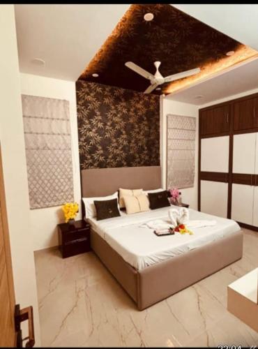 a bedroom with a large bed with a ceiling fan at Madhav Villa in Jaipur