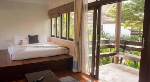 Ένα ή περισσότερα κρεβάτια σε δωμάτιο στο Baan Suan Nuan Ta