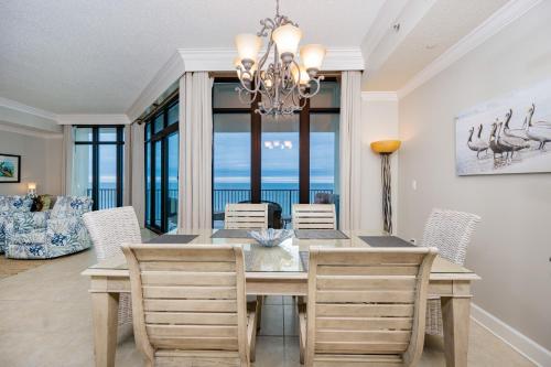 a dining room with a table and chairs at Phoenix West 1002 in Orange Beach