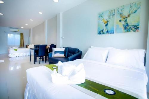 a bedroom with a bed and a living room at The Loom Rangsit in Ban Lam Phak Kut