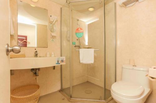 a bathroom with a shower and a toilet and a sink at GreenTree Inn Jiangsu Suzhou Shi Road North Tongjing Road Subway Station Express Hotel in Suzhou