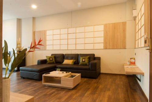 a living room with a couch and a coffee table at The Zenith Residence Hotel in Nakhon Ratchasima