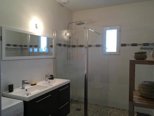 a white bathroom with a sink and a shower at Domaine de Montels in Albias