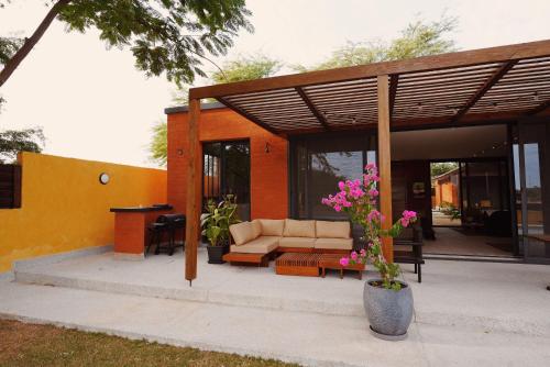 a patio with a couch and a table with flowers at Aerys Village in Somone