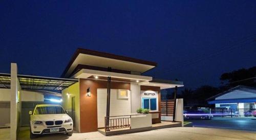 a small house with a car parked in front of it at The Rich Resort in Krabi town