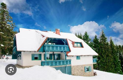 a house with snow on the roof at Apartma Ajdovka Rogla in Rakovec