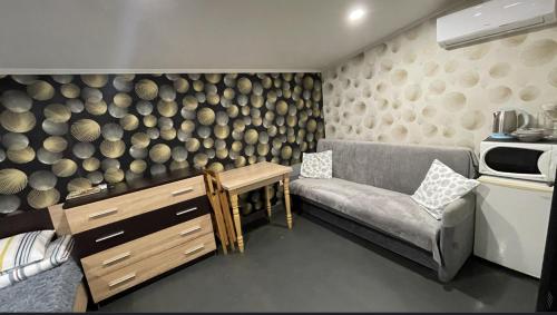 a living room with a couch and a wall of logs at Family in Mukacheve