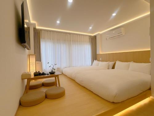 a hotel room with two beds and a television at star house akihabara ueno tokyo in Tokyo