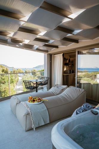 a living room with a large bed and a tub at Zante Sun Resort in Lithakia