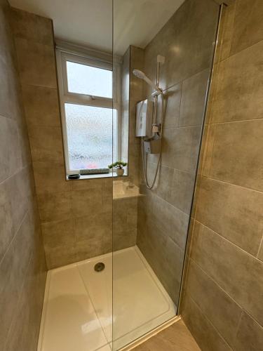 a bathroom with a shower with a glass door at Cleveleys Town Centre in Blackpool