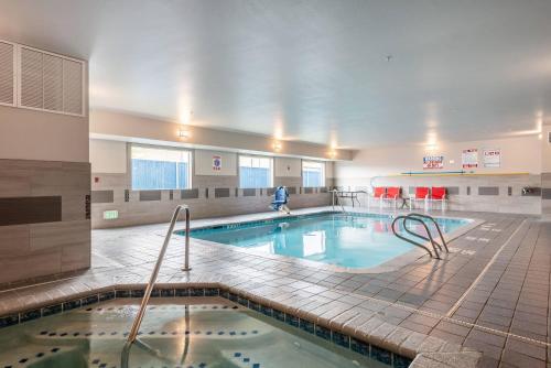a large swimming pool with a person in the background at Quality Inn & Suites Missoula Westside in Missoula