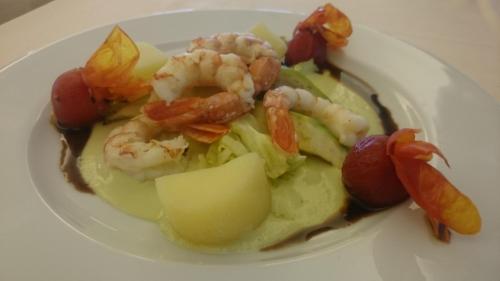 a white plate of food with shrimp and vegetables at Hotel Bristol in Lignano Sabbiadoro