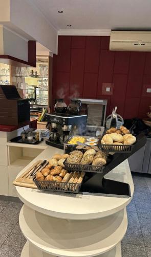 a counter with several trays of pastries in a kitchen at Hotel Falk in Bremen