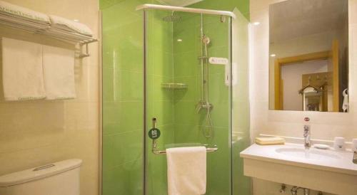 a bathroom with a shower and a toilet and a sink at GreenTree Inn Beijing Shunyi Fengbo Metro Station in Qianfengbo