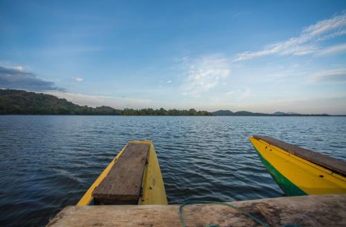 a boat is tied to a dock on a lake at Kevans Casa in Mahiyangana