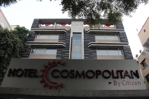 a building with a hotel cosmopolitan sign in front of it at Hotel Cosmopolitan in Ahmedabad