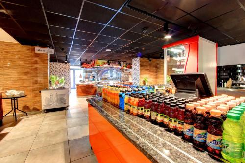 a store with many bottles of soda on a counter at Auto Port Renice in Myślibórz
