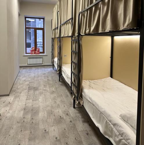 two bunk beds in a room with a wooden floor at Old Town Hostel Gyumri in Gyumri