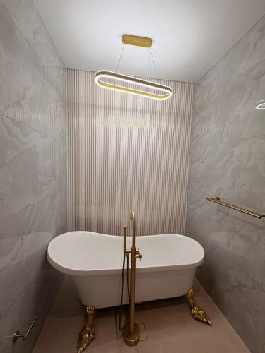 a bathroom with a white tub and a sink at Yoga Luxury Lodge in Thohoyandou