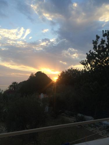 a sunset seen from the balcony of a house at Alkyonis Apartments in Panormos Kalymnos