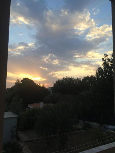 a view of the sunset from the balcony of a house at Alkyonis Apartments in Panormos Kalymnos