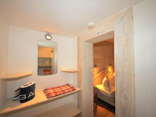 a small room with a bedroom with a bed at ENA Ferien Strandkiste in Juist