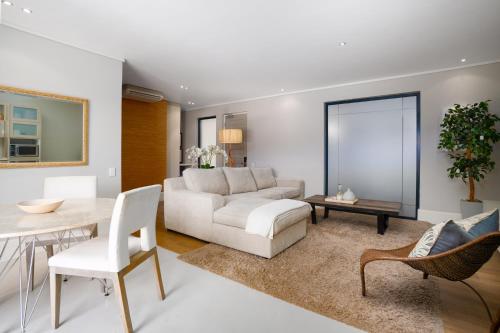 a living room with a white couch and a table at The gallery luxury one bedroom apartment unit 101 in Knysna