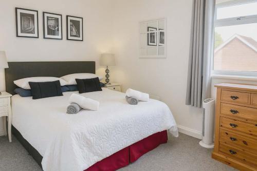 a bedroom with a bed with two toy cars on it at The Nest at Wynncroft in Torquay