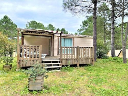 a tiny house with a porch and a deck at ZEcamping 3 étoiles chiens acceptés piscine et bar restaurant in Sartène