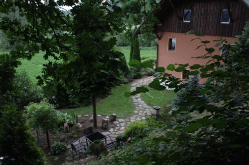 a garden with a stone path next to a building at Dom w Dolinie in Trzcińsko