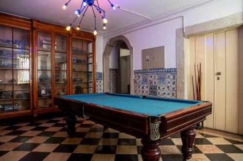 a pool table in a room with a checkered floor at WOT New Lisbon Social in Lisbon
