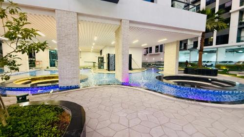 a hotel lobby with two large circular lobbies with blue lights at Petalz Luxury furnished studio with Balcony Swimming Pool Gym Kids play ground in Dubai