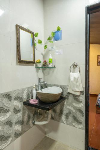 a bathroom with a sink and a mirror at Nysa Villa & Homestays in Igatpuri