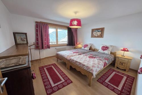 a bedroom with a bed and a window at Bruyères B22 in Verbier