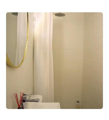 a bathroom with a shower and a toilet and a mirror at Acogedora casita con barbacoa in Candeleda
