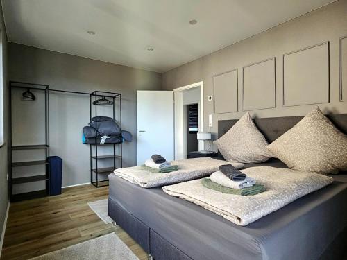 Una cama con dos almohadas encima en una habitación. en Moderne 3-Zimmer-Wohnung mit Panoramablick, en Bad Berleburg