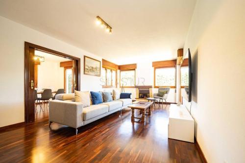 a living room with a couch and a table at Casa Costera Gijón By Silastur in Gijón